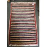 A modern striped woollen mat 56 x 91 cm