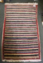 A modern striped woollen mat 56 x 91 cm