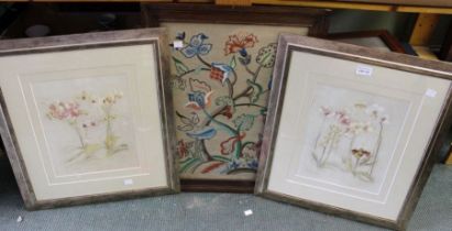 An oak framed woolwork tapestry panel and a pair of framed floral prints