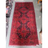 A woven woollen floral design long rug 86 x 193 cm