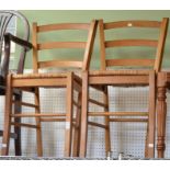A pair of rush seated kitchen chairs