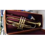 A retro cased students trumpet with mute