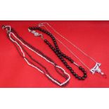 A collection of four various necklaces, includes garnets and pearls