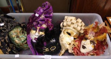 Five decorative masks in a crate