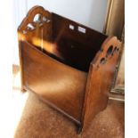 A carved oak magazine rack