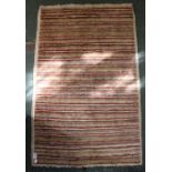 A striped woven woollen mat 76 x 118 cm
