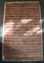 A striped woven woollen mat 76 x 118 cm