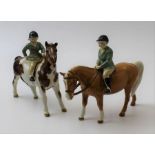 Two mounted Beswick pony's green jacketed riders (one A/F)