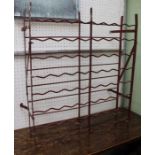 A red finished Continental cellar wine-rack