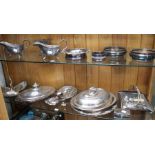 Two shelves of Silver plated items to include serving dishes, bottle coasters, etc