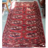 A geometric patterned woven woollen carpet with high knot count 121 x 189 cm