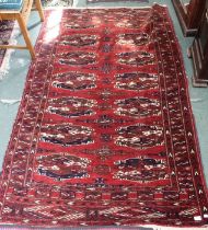 A geometric patterned woven woollen carpet with high knot count 121 x 189 cm