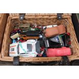 A wicker picnic basket containing a selection of die-cast toys