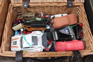 A wicker picnic basket containing a selection of die-cast toys