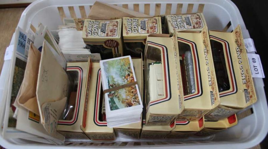 A crate containing a selection of die-cast and other motoring ephemera
