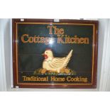 A wooden sign depicting the cottage kitchen with hen and eggs