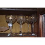 A set of six gilded decorative wine glasses