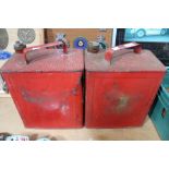 Two red vintage fuel cans with brass tops