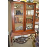 A 19th century two-door mahogany display case glass fronted