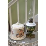 Antique pottery stilton cheese dome and an oil lamp
