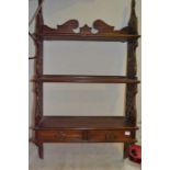 An early 20th century pierced side wall hanging set of shelves