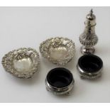 A pair of Victorian salts, Birmingham 1886, a Victorian embossed pepper pot, Birmingham 1892, a pair