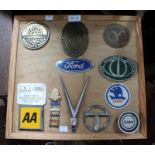 A presentation board mounted with metal car manufacturer badges, includes a Bugatti Owners Club