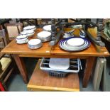 A modern mahogany coloured extending dining table on four block legs