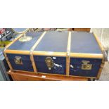 A wooden banded blue painted travel trunk