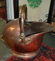 A 19th century copper helmet coal scuttle