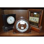 A black marble mantle clock with tow other similar examples