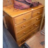 A modern pine five drawer chest