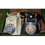 Two vintage dial telephones - one black one ivory