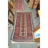 A woven woollen geometric patterned floor rug