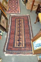 A woven woollen geometric patterned floor rug