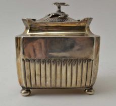 A Victorian silver tea caddy, fluted body, with hinged cover having floral knop, raised on four bun