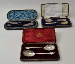 Three cased sets of silver food serving implements includes a pair of silver jam spoons with mother-