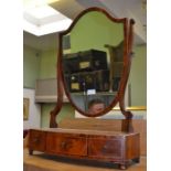 An early 20th century mahogany shield shaped dressing table mirror on a three drawer