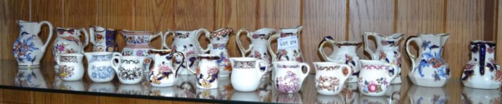 A shelf of small sized jugs - mainly 'Masons'