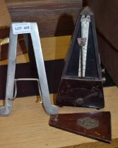 Maelzel vintage metronome with a metal piano top music stand