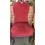 A pair of claret upholstered Queen Anne chairs with shell carved knees