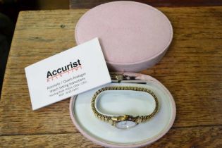 An Accurist Mean Time ladies watch with gold elasticated bracelet strap