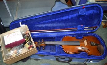 Students violin and bow cased together with many accessories