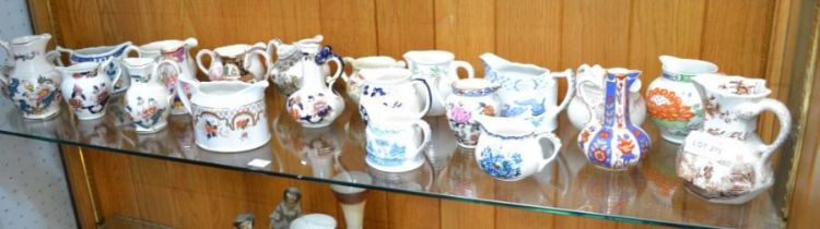 A shelf of small sized jugs - mainly 'Masons'