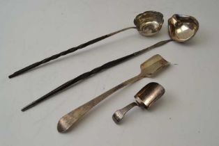 A Georgian silver caddy spoon, a Victorian Britannia standard Stilton scoop, and two twisted whale b