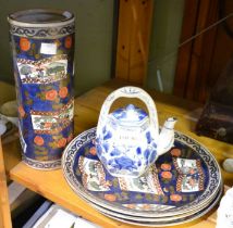 Three Chinese dinner plates, a cylindrical vase and a teapot