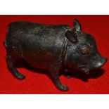An Asian figure of a pig standing four square and 9 cm long