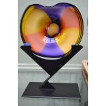 A glass multi-coloured dish indistinctly signed on metal stand