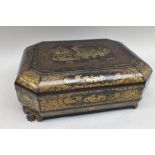 An early 19th century Chinese Canton black lacquer games box with gilded and red border decoration,