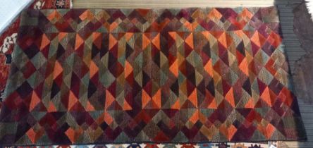 A late 20th century wool covered geometric Harlequin rug, 93cm x 102cm